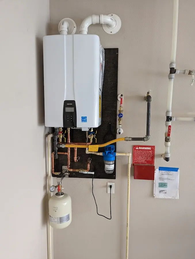 Professional plumber installing copper piping in a Brooklyn home